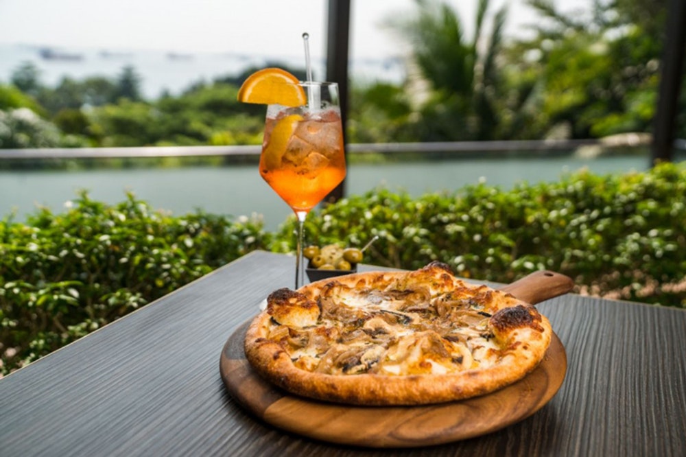 The Cliff restaurant view with pizza and aperol spritz