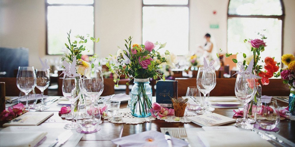 The White Rabbit table dressed fro event with flowers